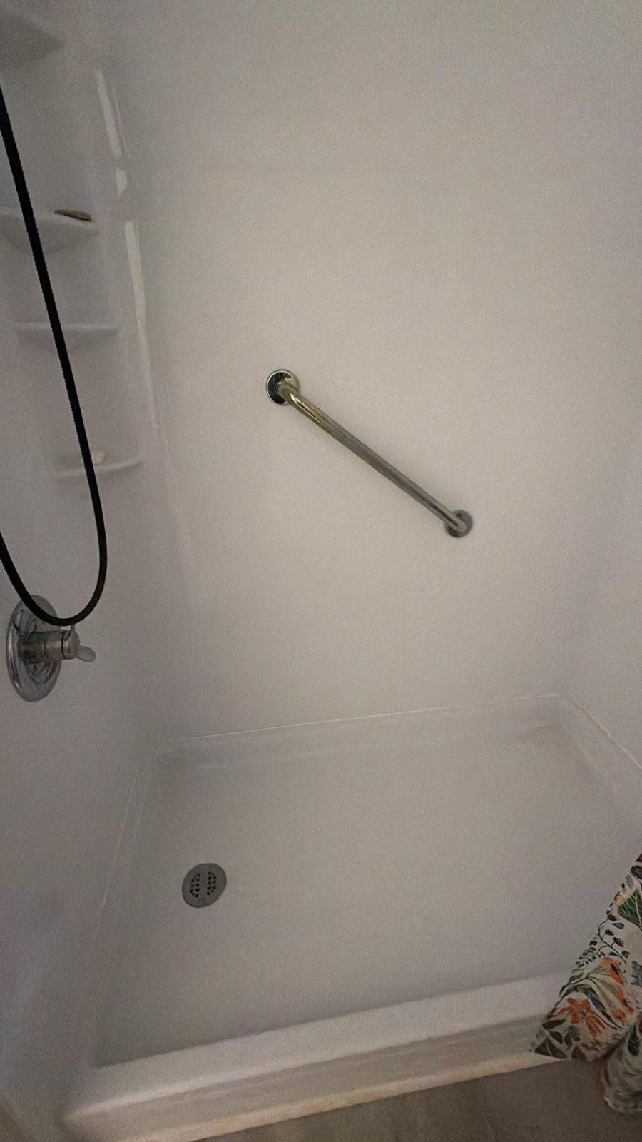 Clean shower wall and grab bar after cleaning